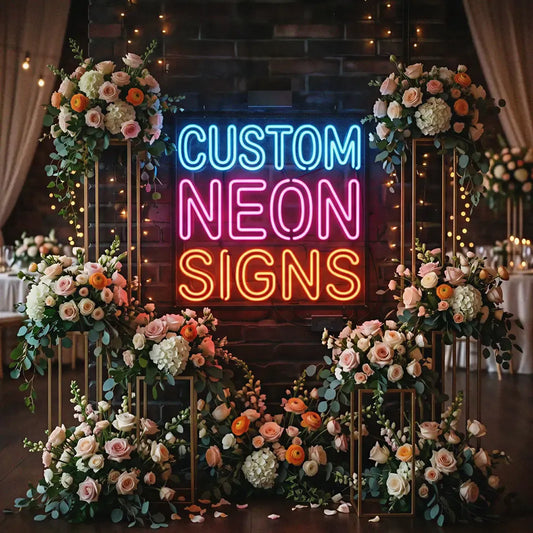 Neon sign reading 'Custom Neon Signs' surrounded by floral decorations.