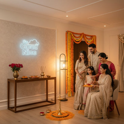 Lux Neon Cloud Nine neon sign above a bed decorated with rose petals and fairy lights. Couple in traditional attire sits on the bed.