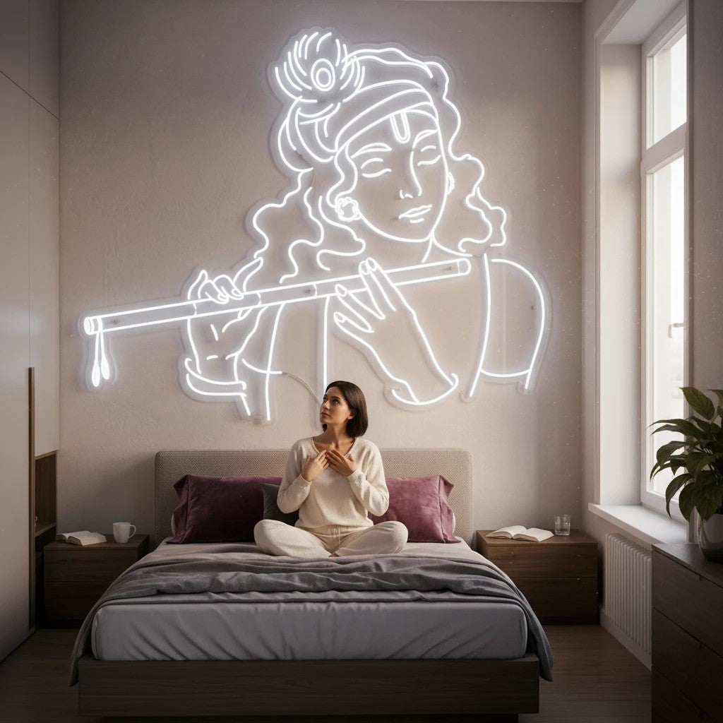 Lux Neon Krishna neon sign with flute, white outline, above a woman meditating on a bed.