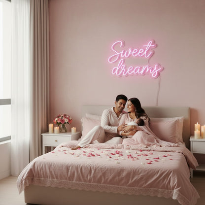 Lux Neon Sweet Dreams neon sign above a baby crib in a pink nursery. Two women in pink dresses hold a newborn.