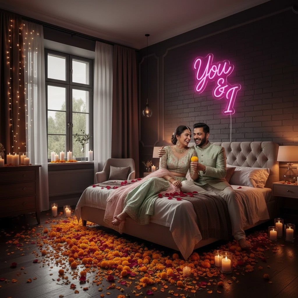 Lux Neon You and I neon sign in bright pink script, mounted on a brick wall above a bed.